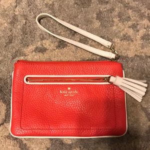 Coral in color Kate Spade wristlet